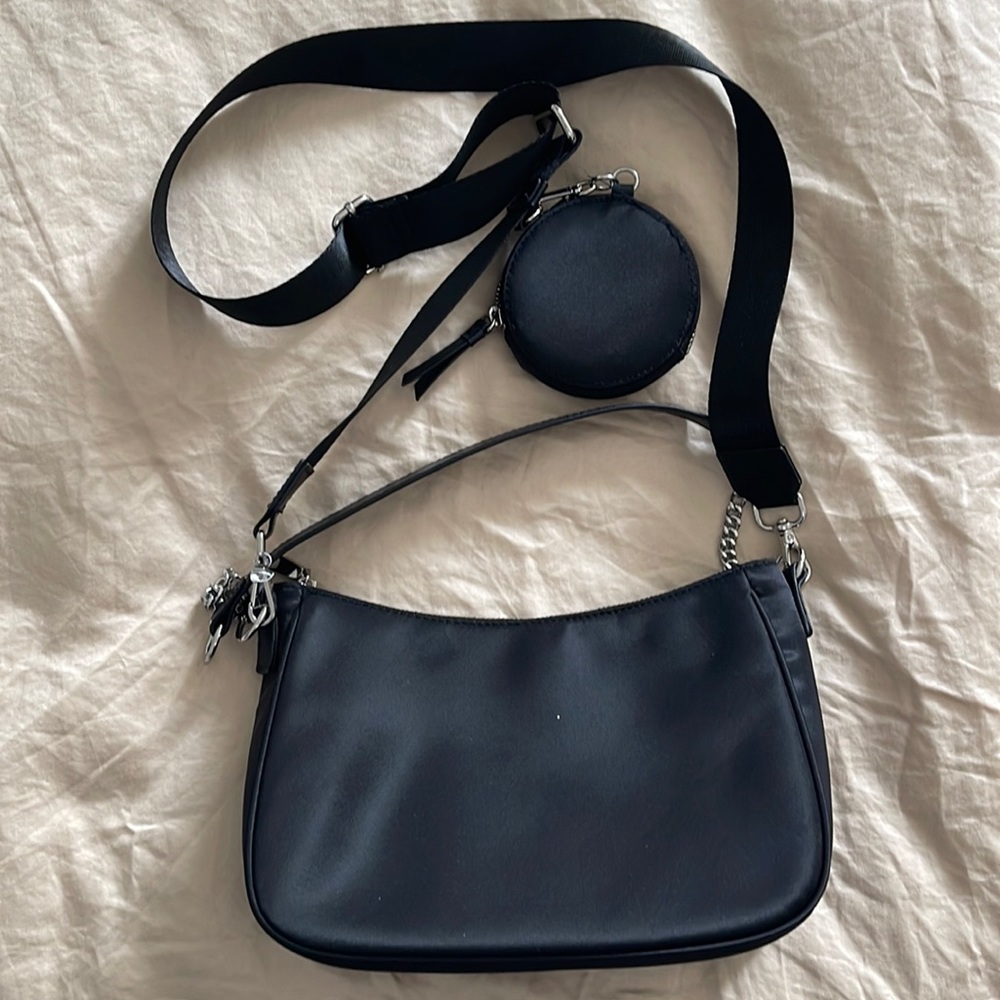 Black nylon crossbody and over the shoulder bag with silver hardware and pouch